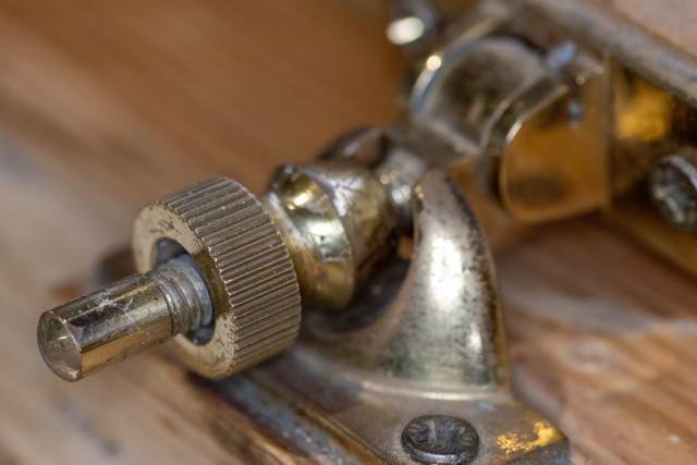 A brass fastener on the meeting rail of a sash window